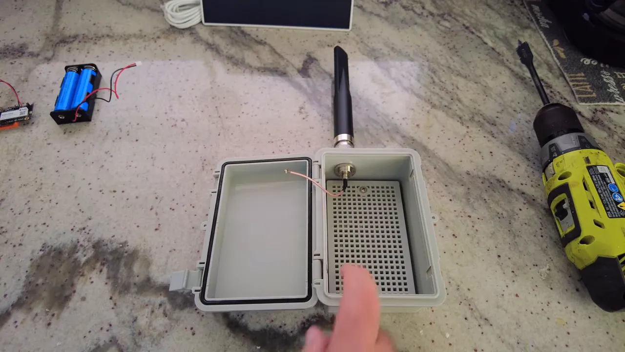 installed antenna on waterproof enclosure with bulkhead connector and internal coax visible