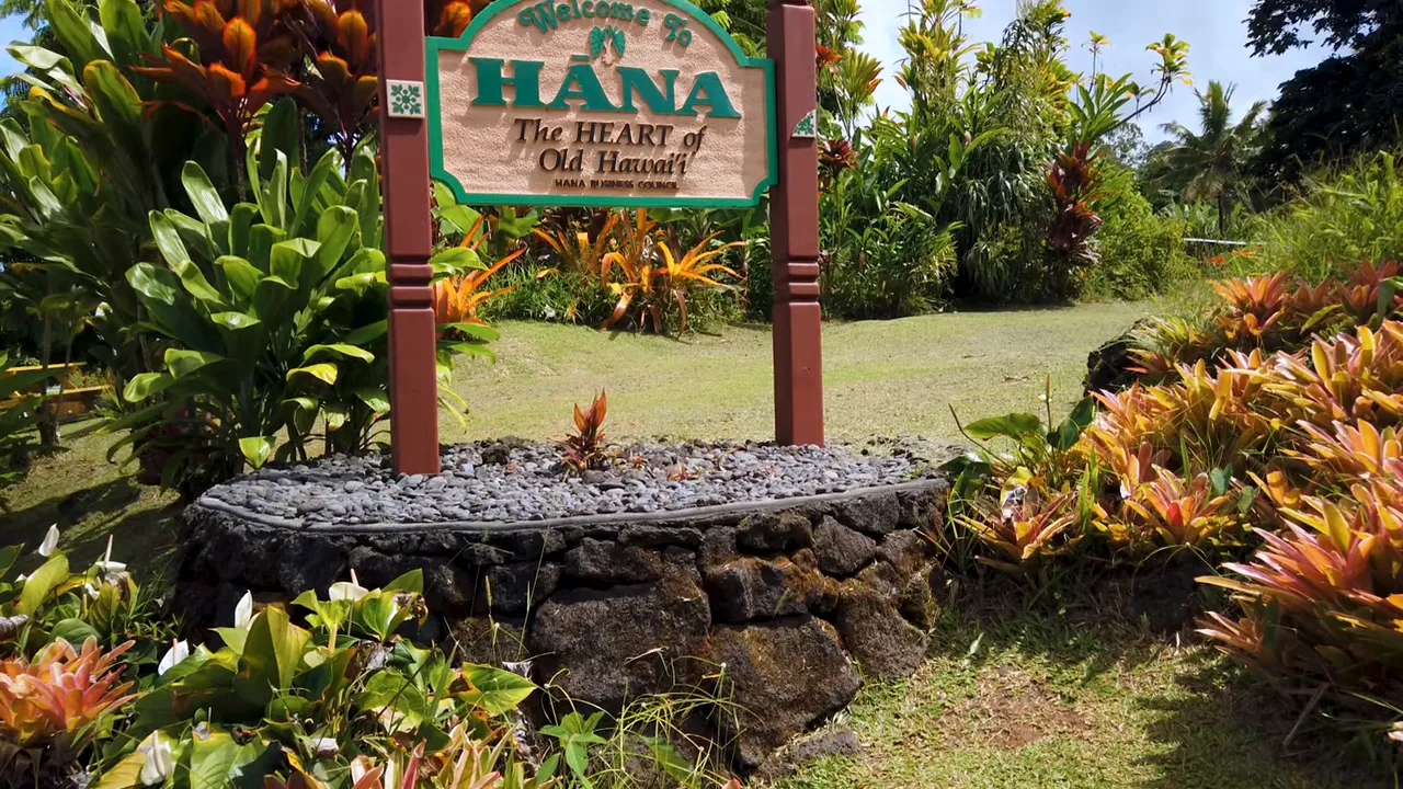 welcome to hana sign at town entrance with tropical foliage