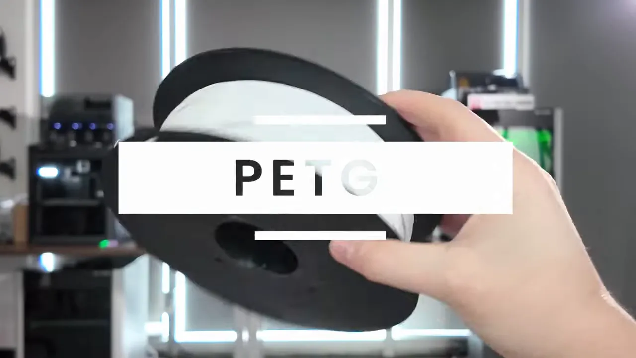 Hand holding a PETG filament spool with PETG title overlay