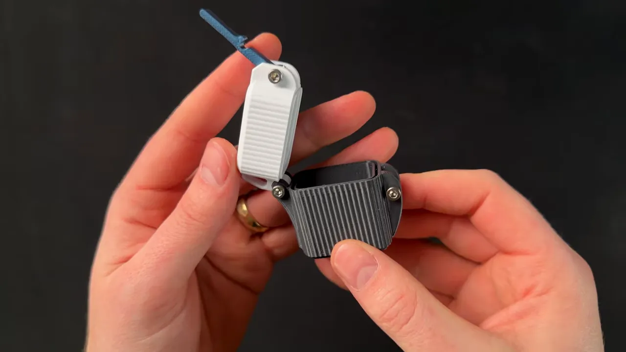 Close-up of a 3D printed snap-lid container held in hands with the lid open