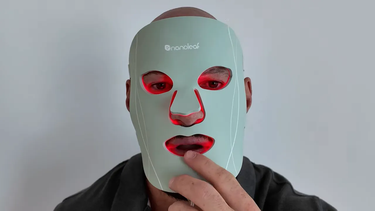 Nanoleaf LED face mask worn on a person, front view with red LEDs glowing and Nanoleaf logo visible