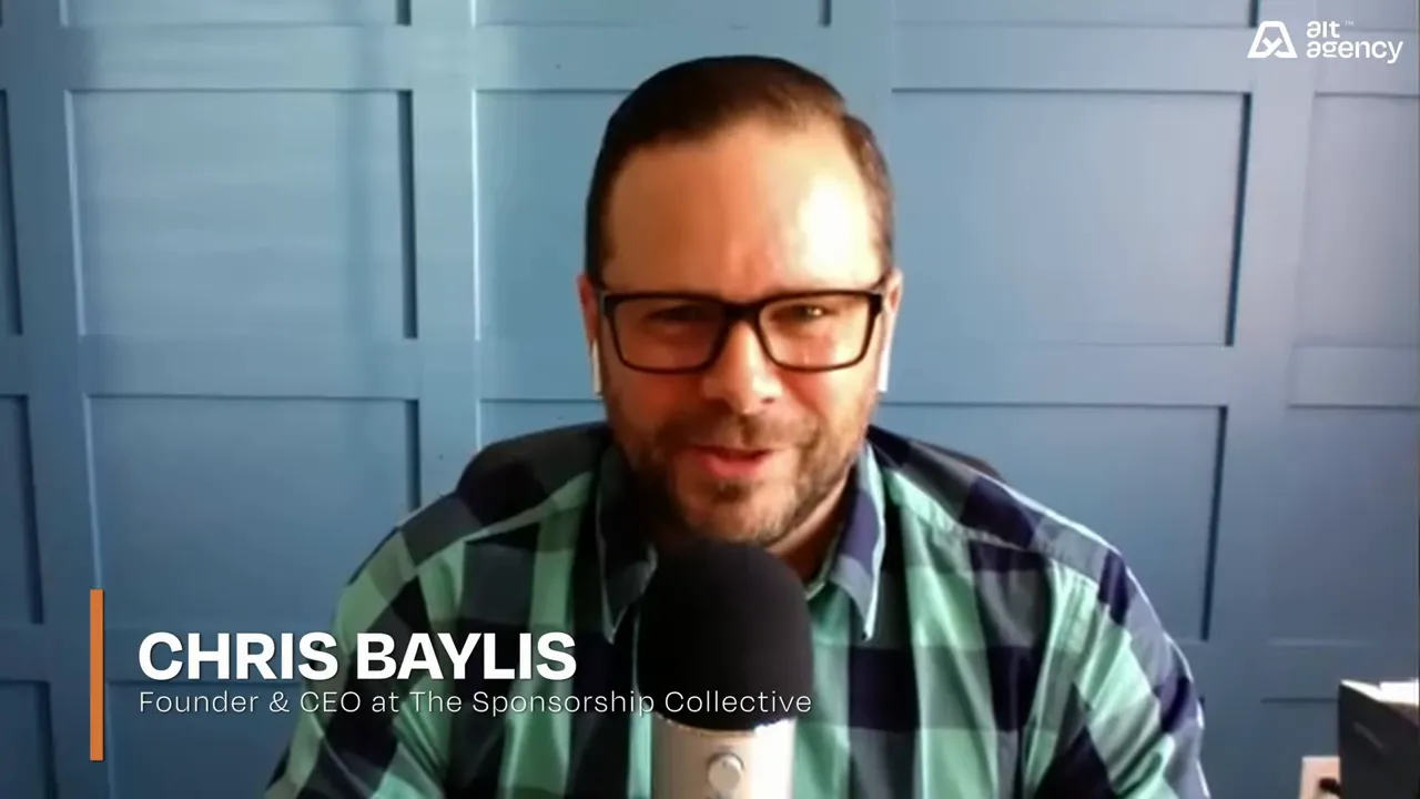 Guest on a video call wearing glasses and a plaid shirt, speaking into a microphone with a lower-third title graphic visible.