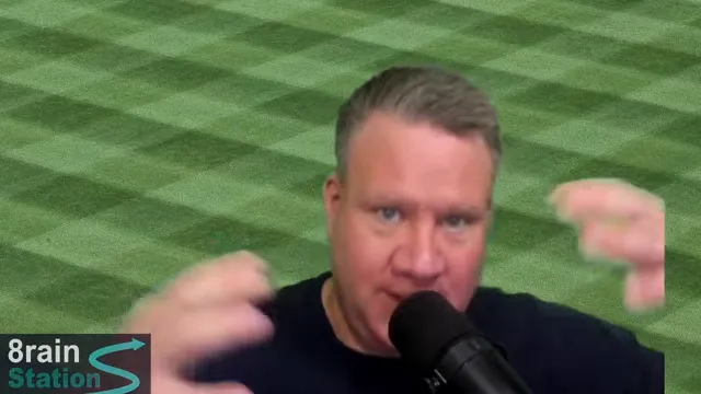 Speaker holding both hands apart while speaking into a microphone