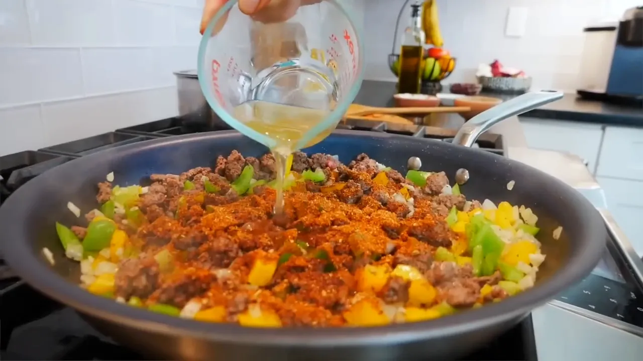 Adding taco seasoning and broth