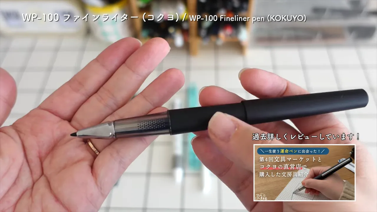 黒いファインライターペンのキャップを外した状態を手のひらにのせている