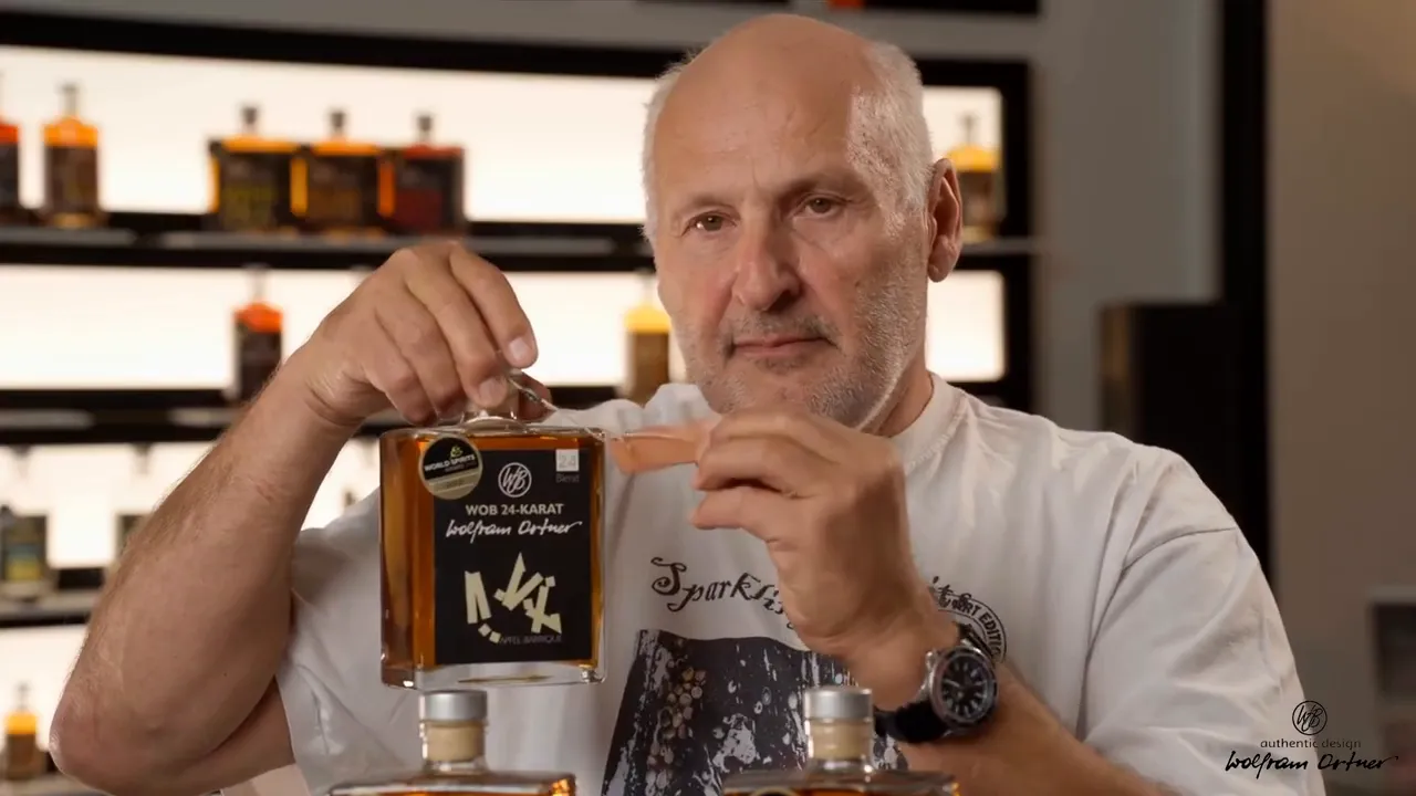 Close-up of a WOB 24 Karat bottle with the metal pendant and pink hang-tag being displayed for personalization