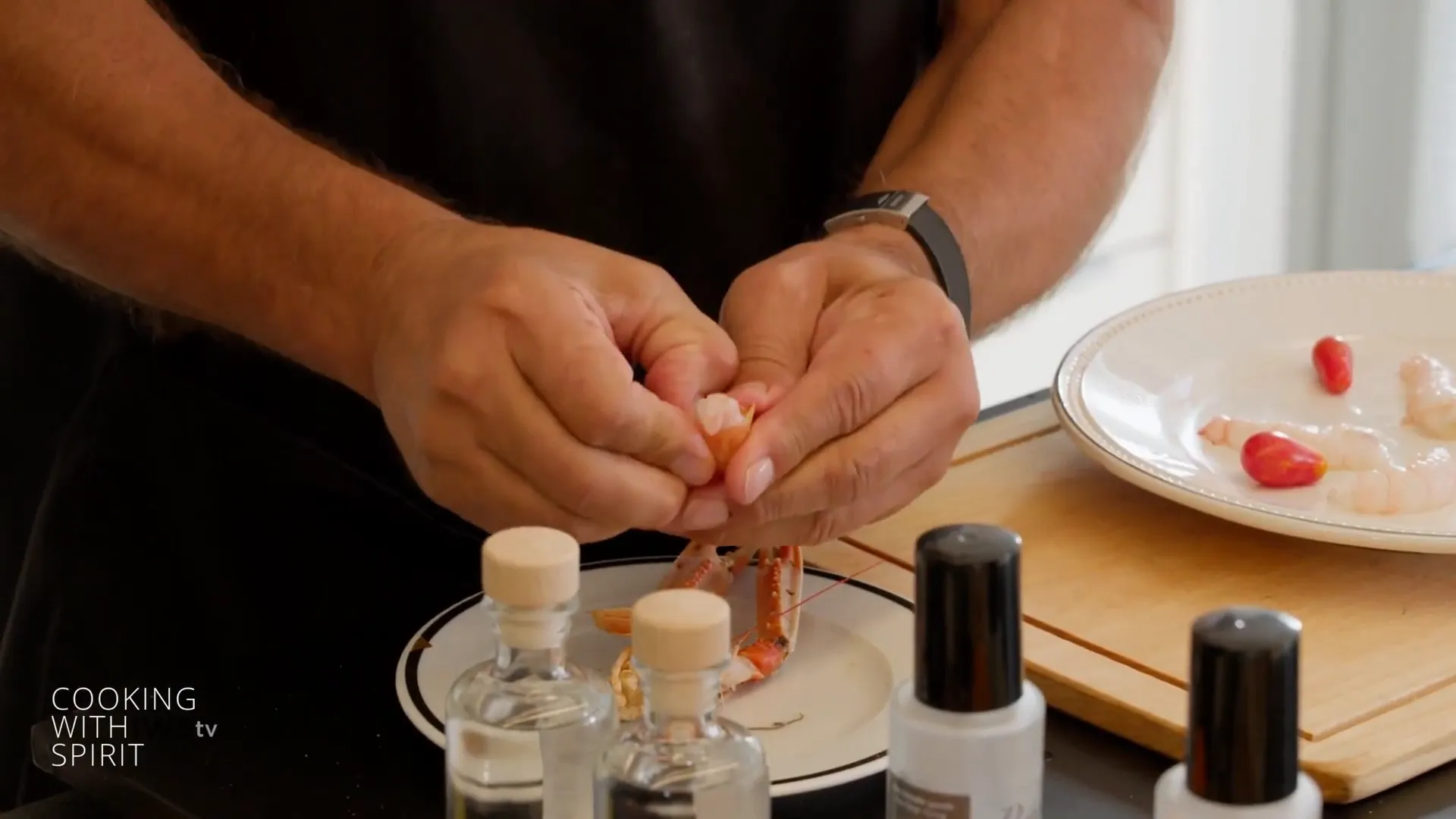 Hands removing head and tail from scampi before shelling