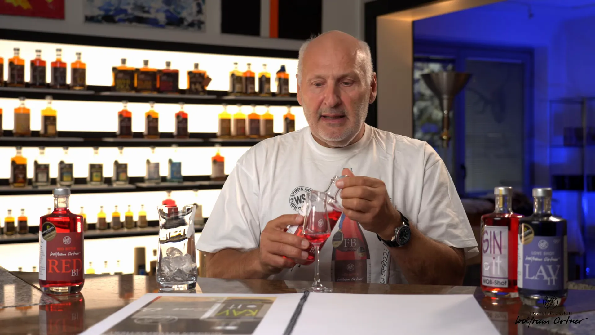 Pouring Red:Bi into a tasting glass — showing color and viscosity