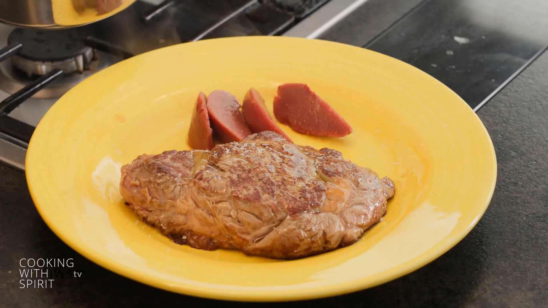 Plated tomahawk steak with quince red wine sauce and olive oil drizzle
