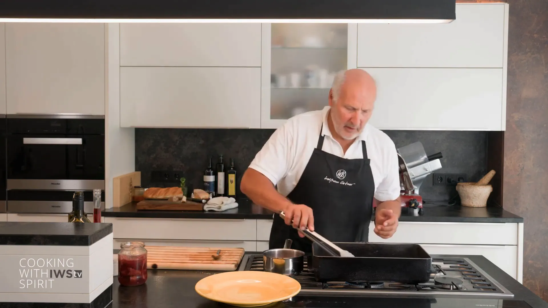 Flipping tomahawk steak in the pan for even cooking