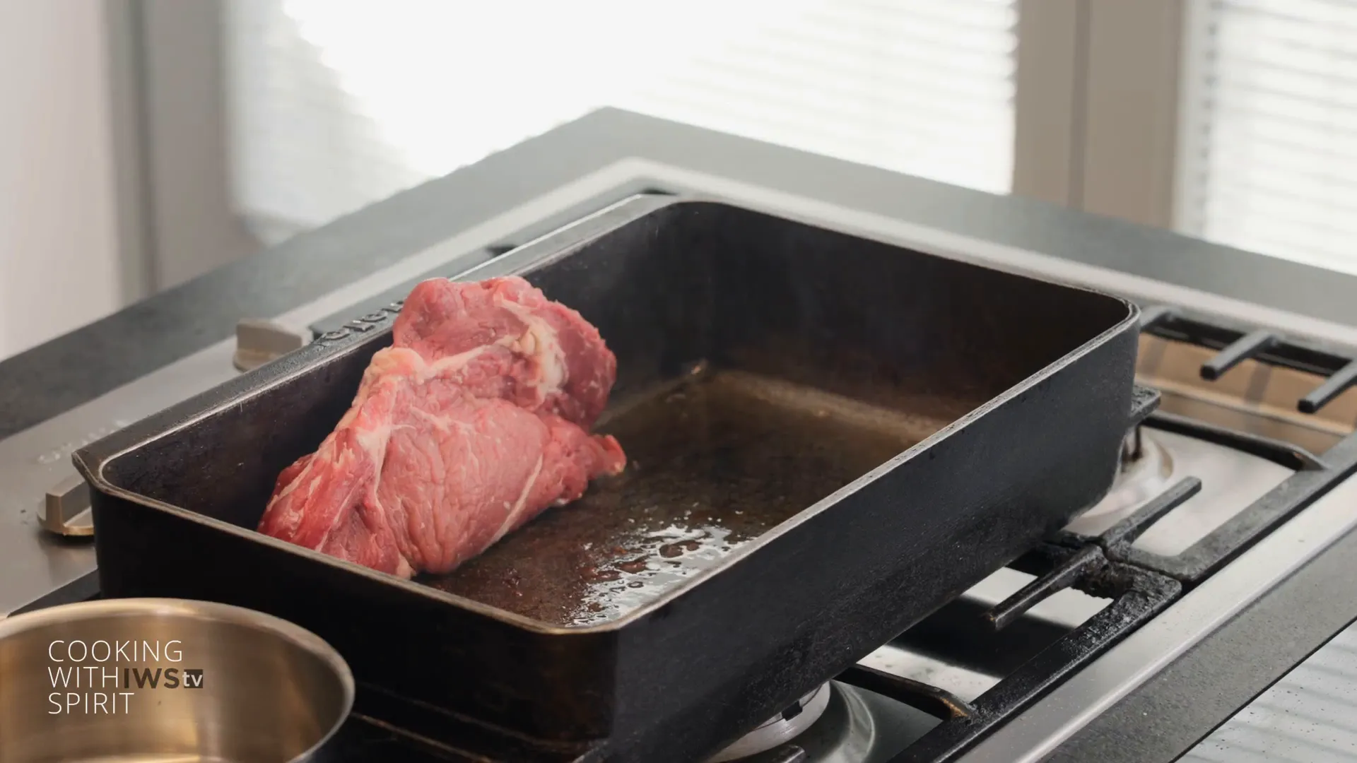Tomahawk steak searing fat side down in the pan
