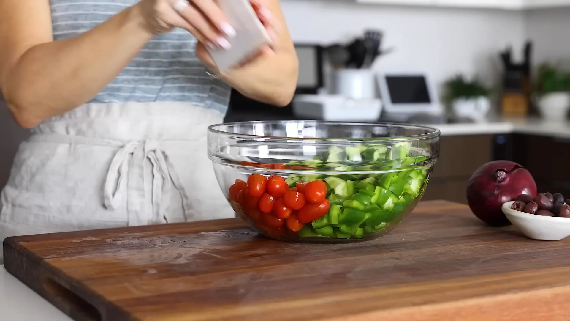 Adding tomatoes to the mixing bowl