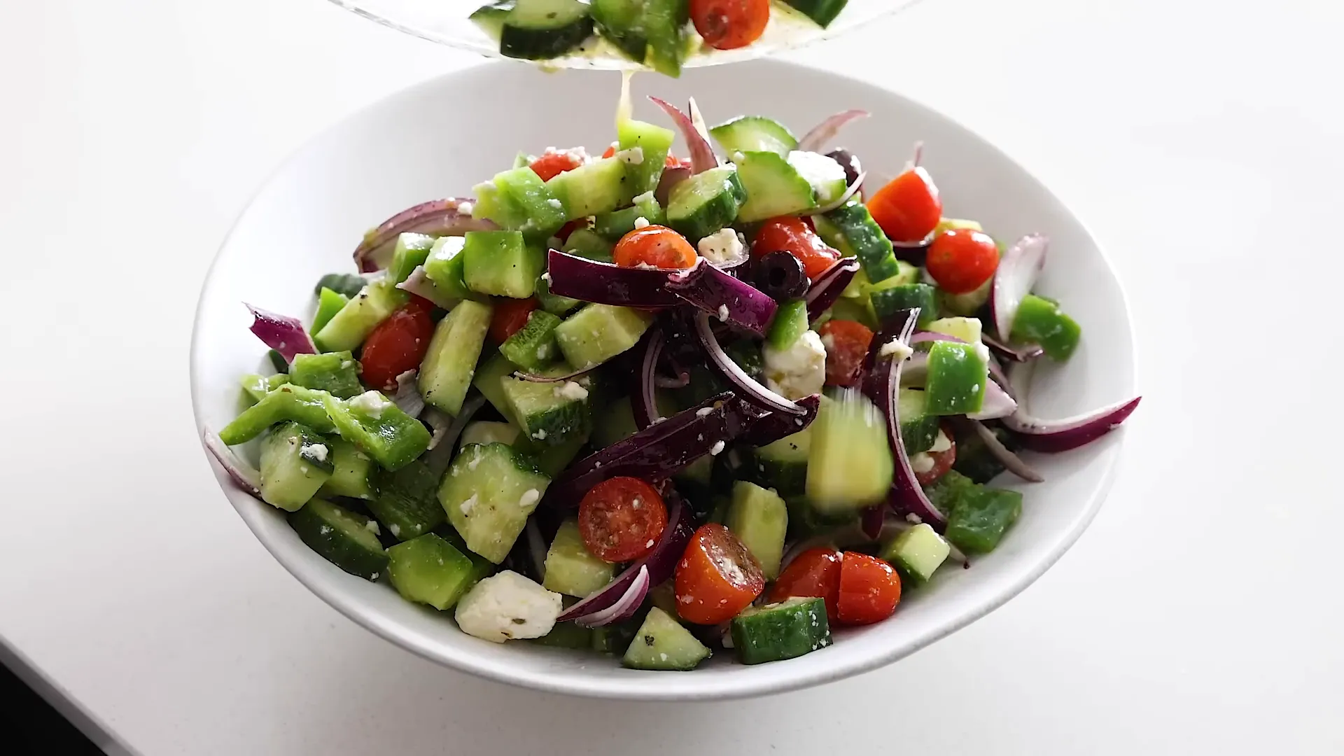Transferring salad to a serving bowl