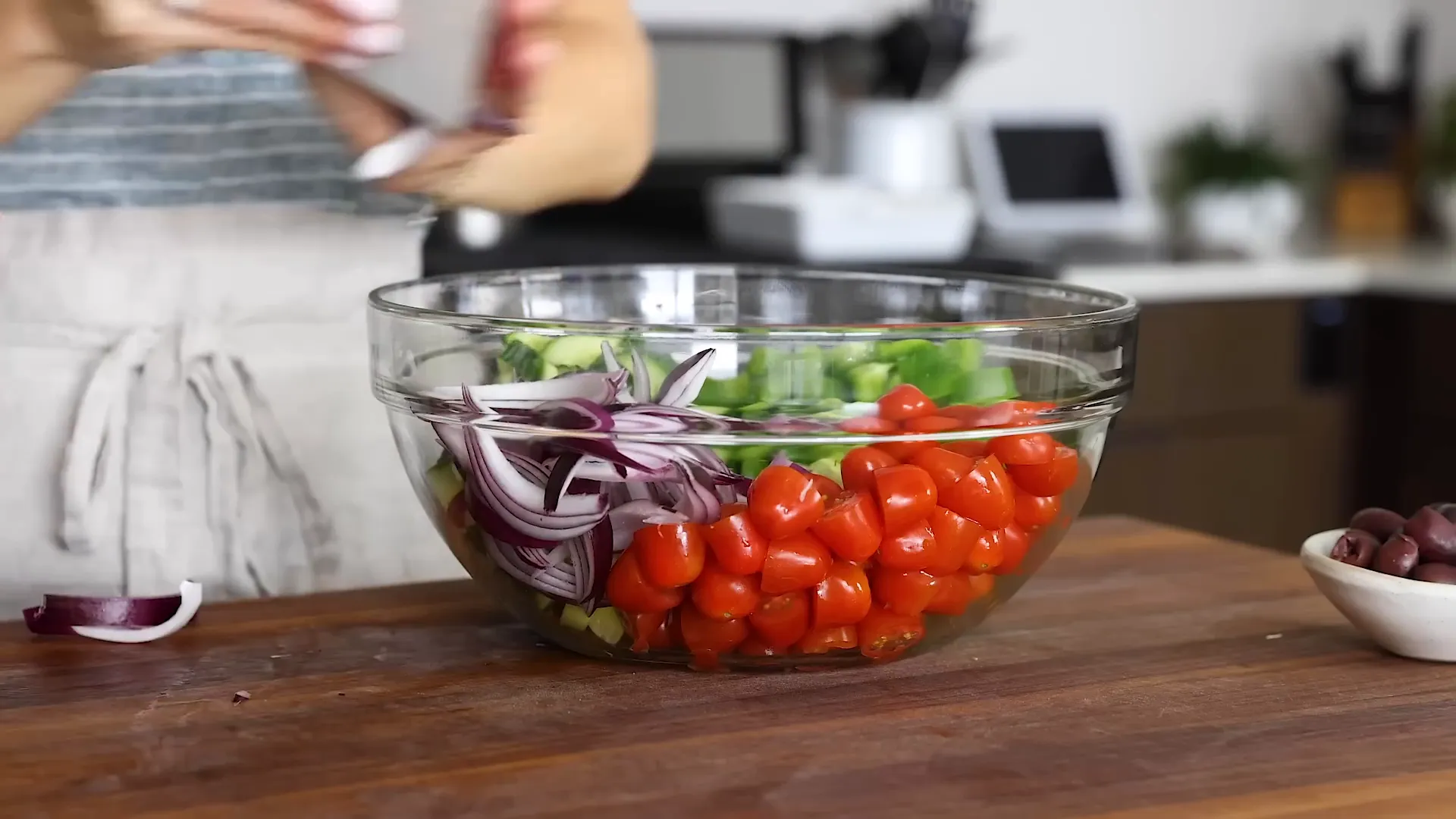 Adding red onion to the bowl