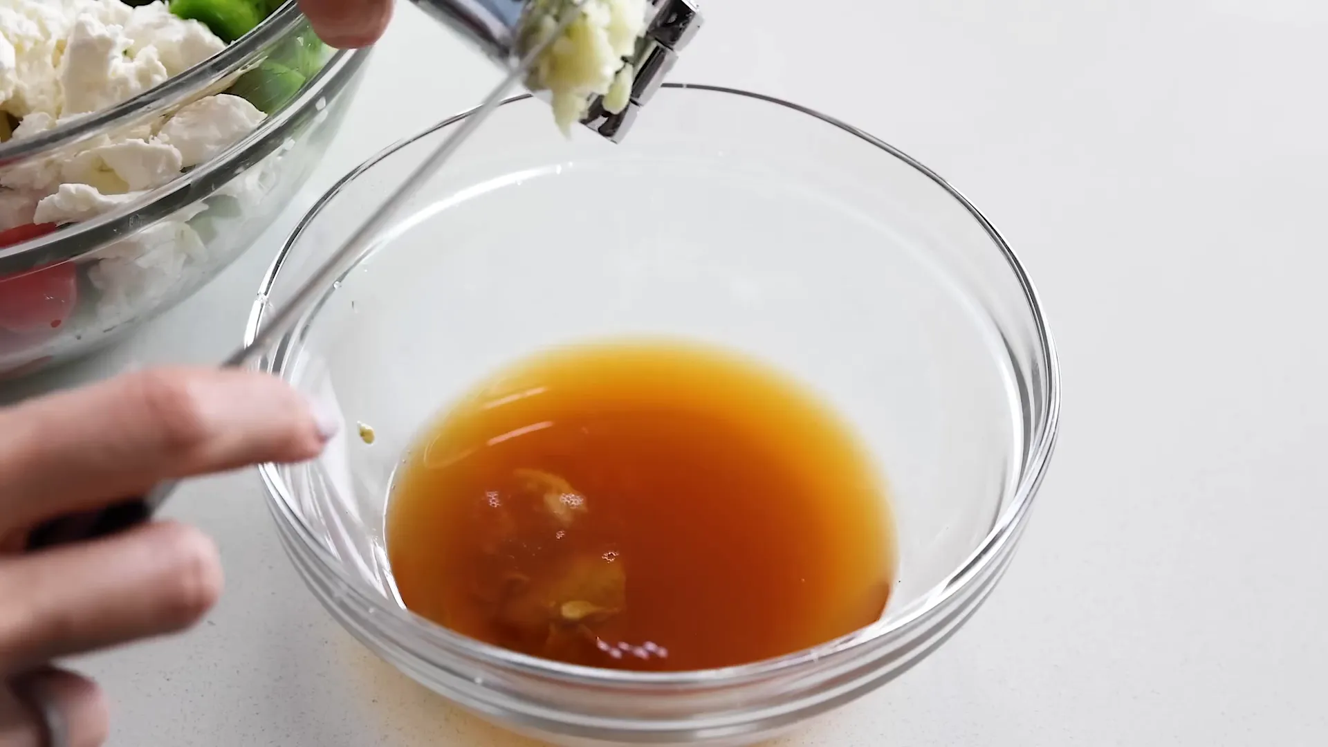 Adding feta cheese to the bowl