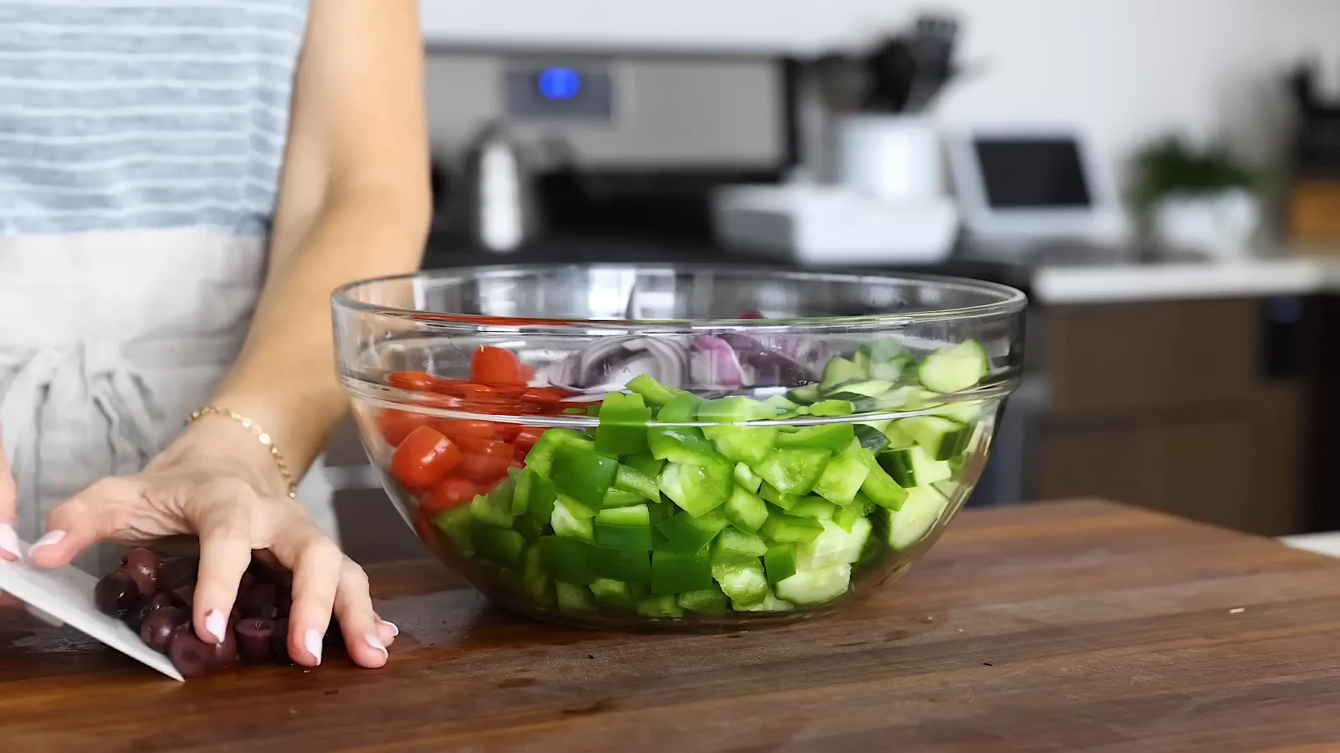 Adding olives to the bowl