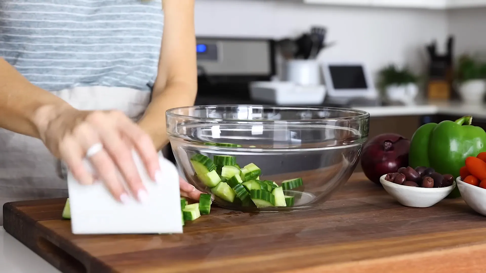 Adding cucumber to the mixing bowl