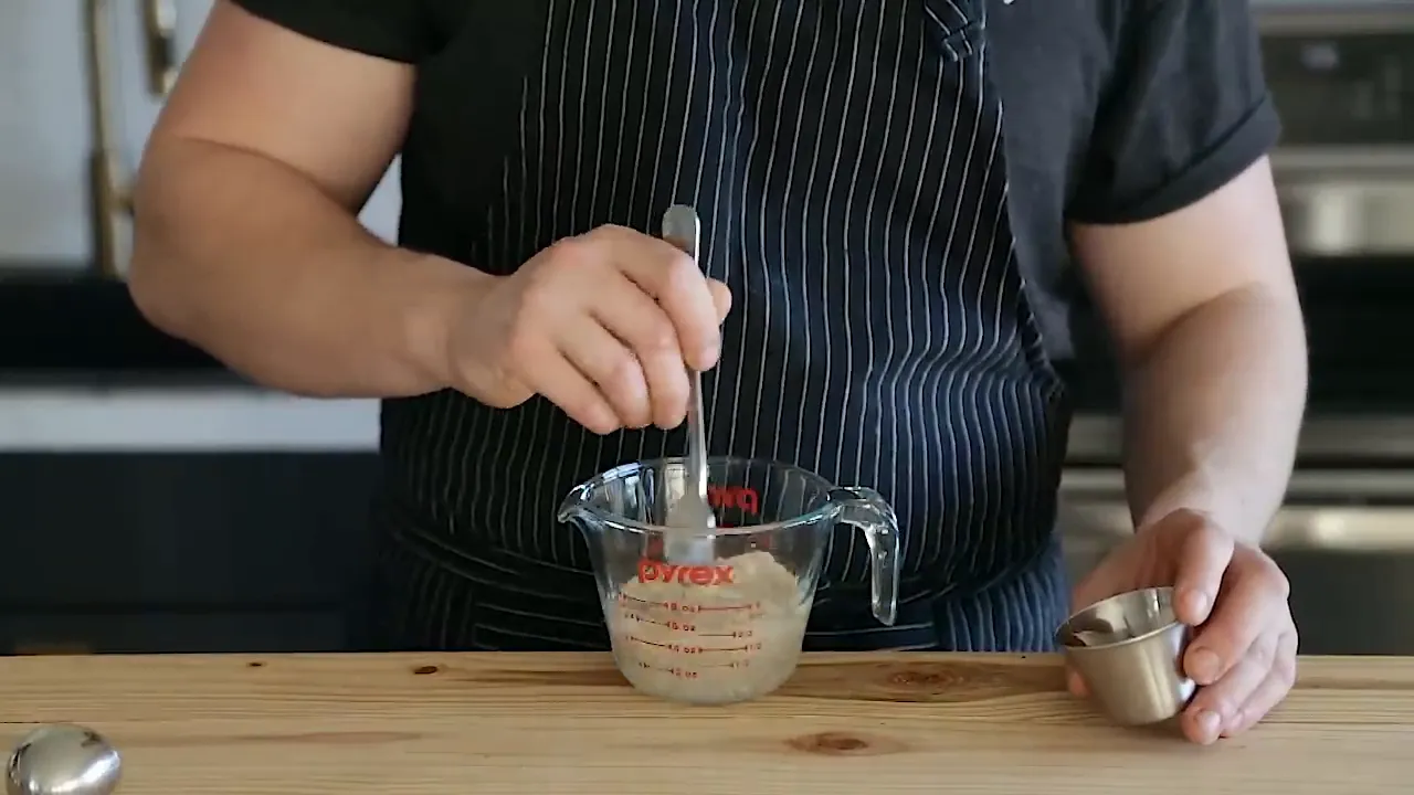 Mixing dough ingredients to form croissant dough