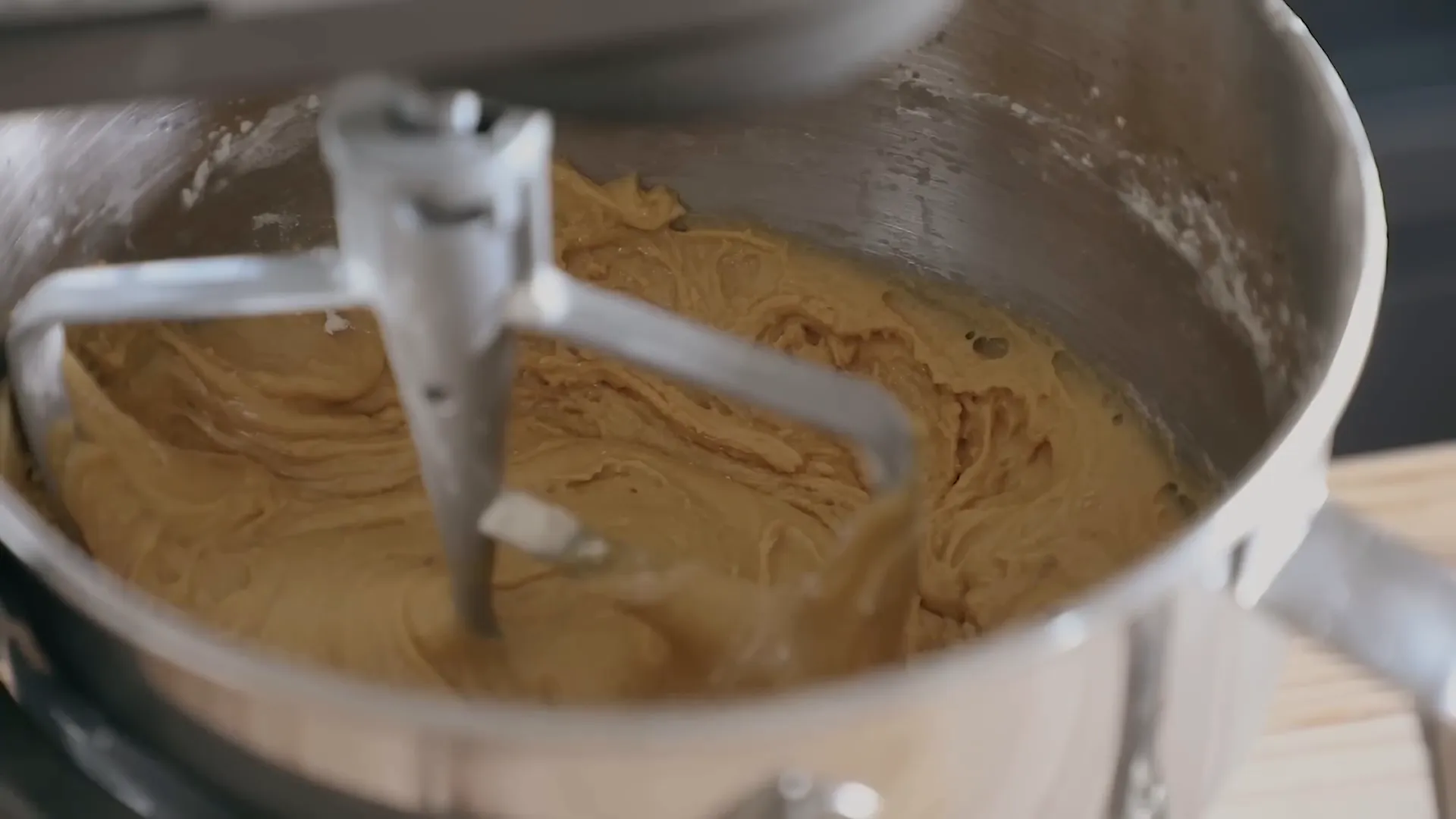 Mixing cookie dough in stand mixer with flour being added