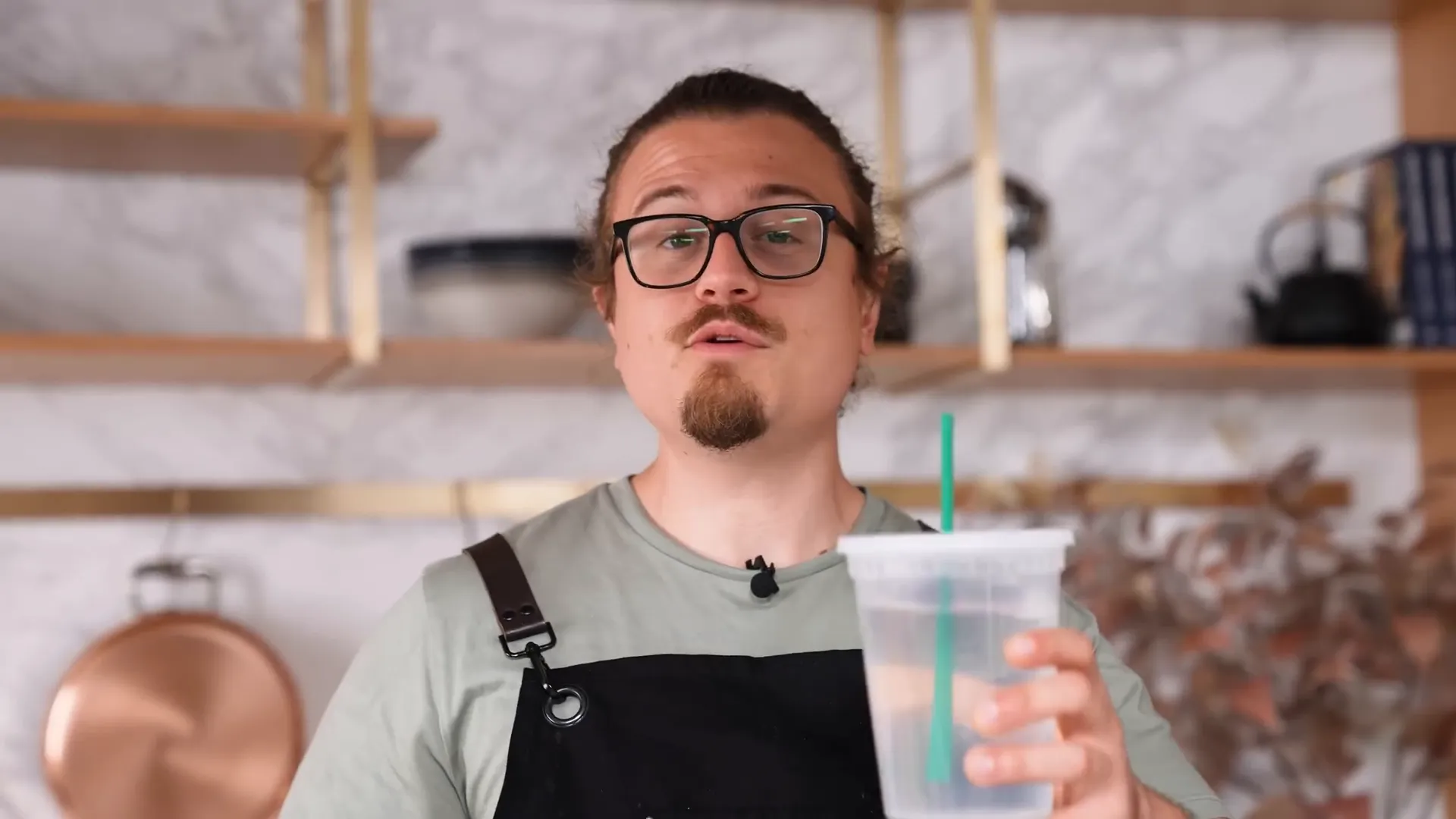 Chef drinking from storage container using straw