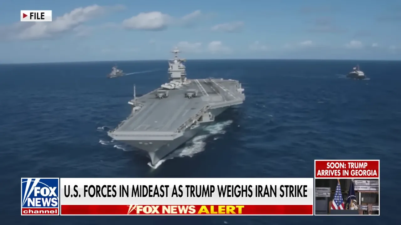 Aircraft carrier underway at sea with escort ships visible