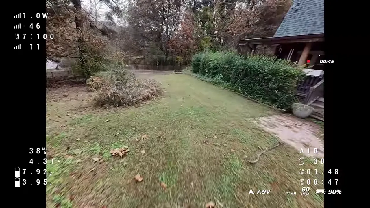Pavo Pico II forward flight over a yard with telemetry overlay, showing a level, stable horizon.