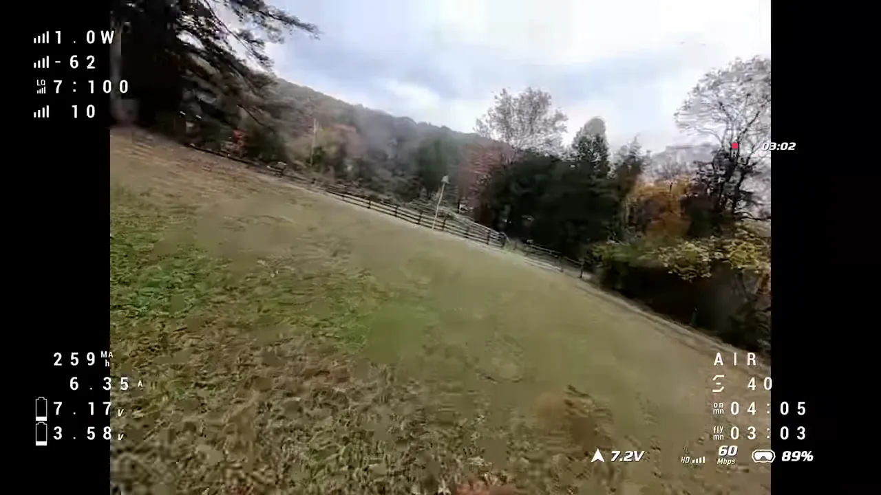 Pavo Pico II forward flight over a field with telemetry overlay showing battery voltage, timers and link information