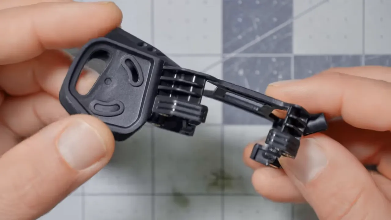 Close-up of BETAFPV Pavo Pico II canopy showing bobbin soft-mount and camera mount held between hands