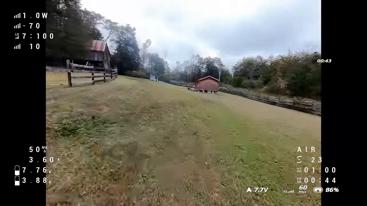 Pavo Pico II FPV forward flight with telemetry overlay showing signal bars, link quality, battery voltage and latency