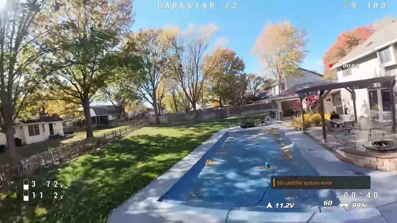 Poolside aerial shot with on-screen telemetry showing 00:40 flight time and 11.2 volts