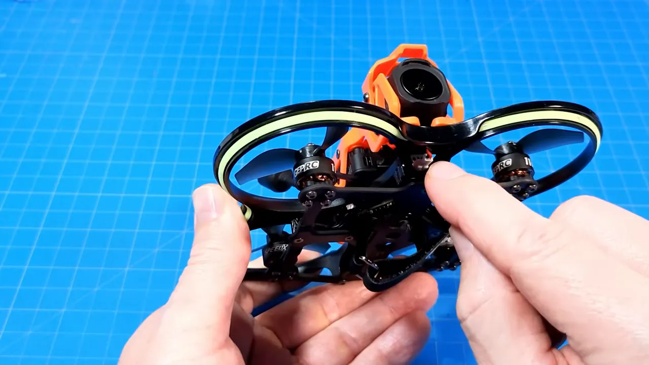 Finger indicating the prop protection mounting point on the DarkStar22 molded plastic canopy, showing the duct and motor.