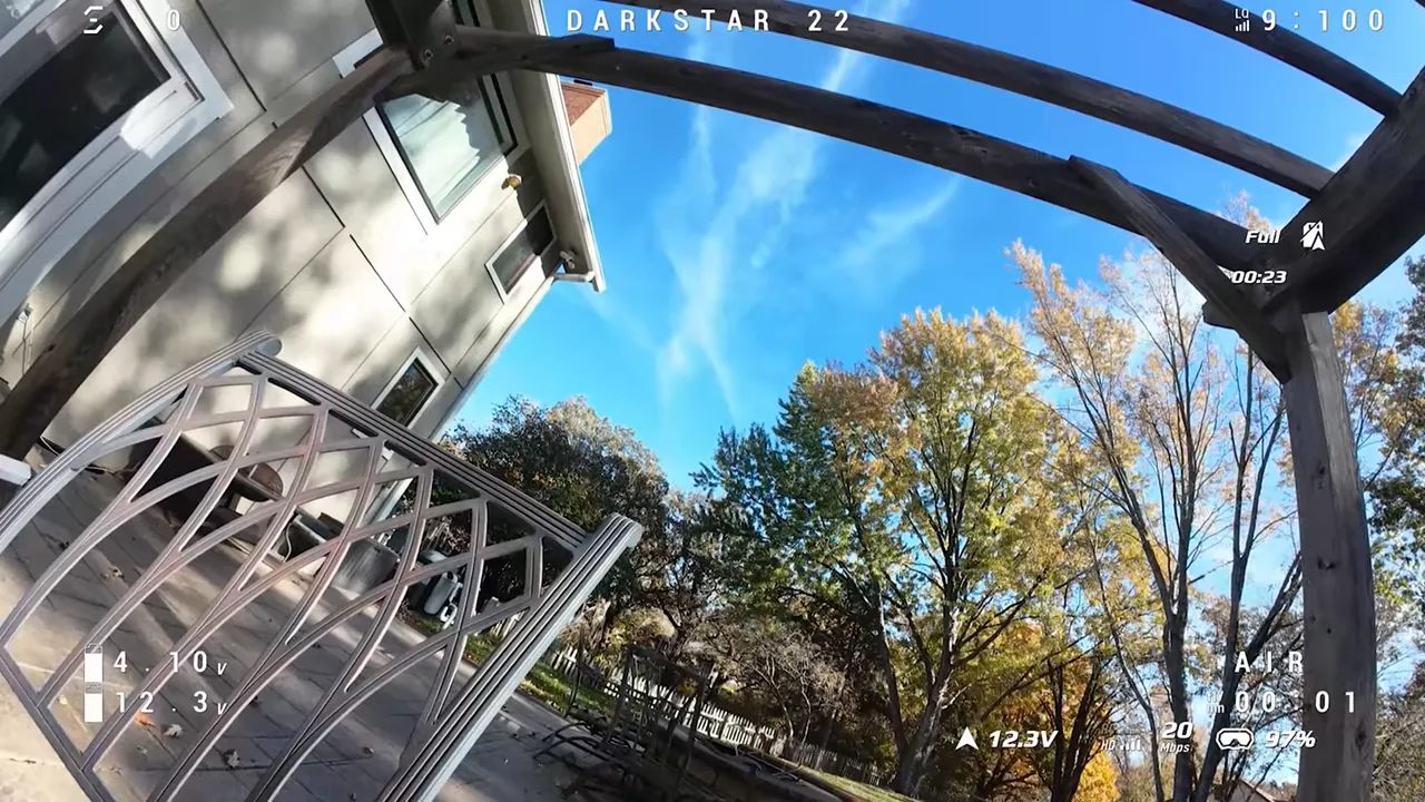 POV from DarkStar22 under a pergola with blue sky and trees; on-screen telemetry shows battery voltage and timer