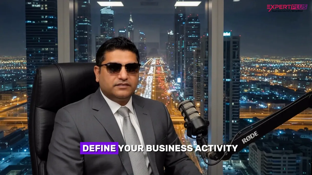 Presenter in suit with Dubai skyline and on-screen text 'DEFINE YOUR BUSINESS ACTIVITY'