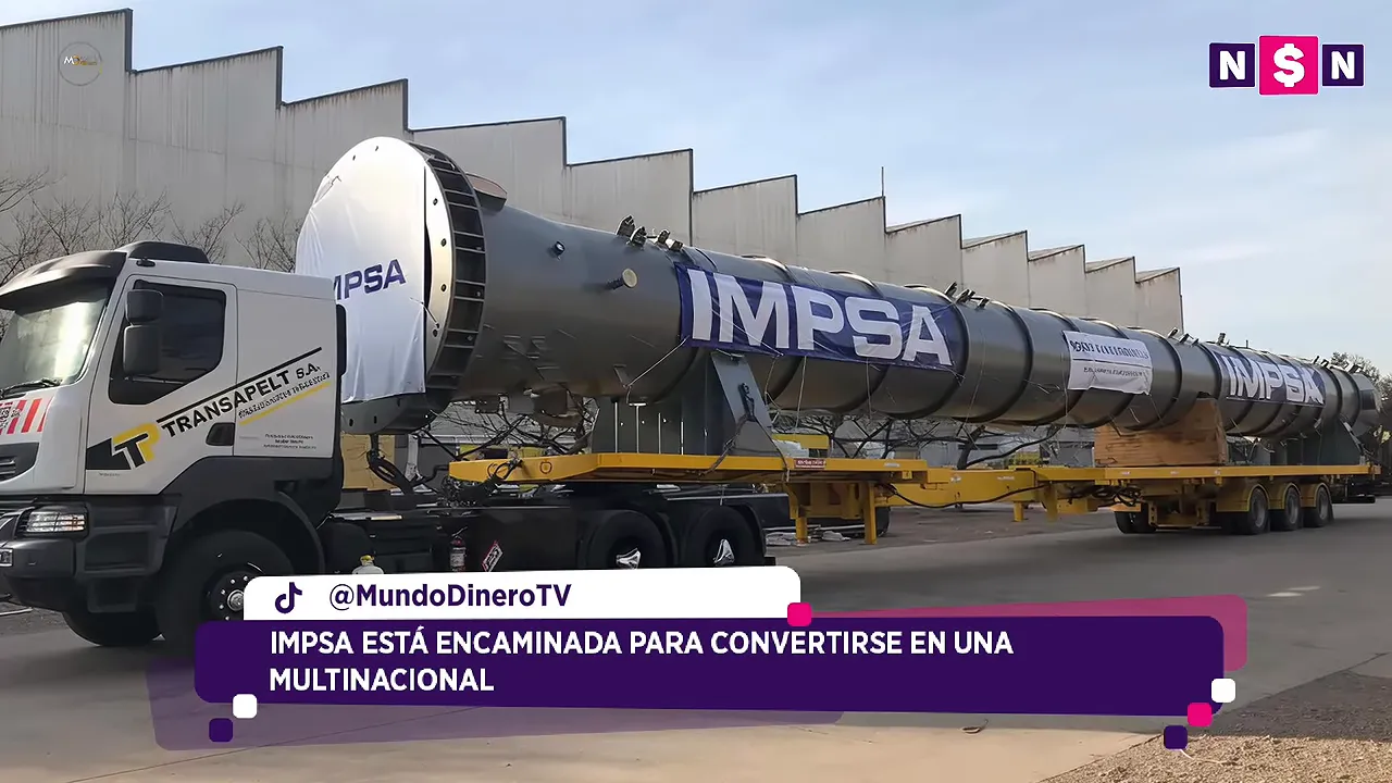Gran pieza industrial con el nombre IMPSA junto a un cami�n y una nave de f�brica