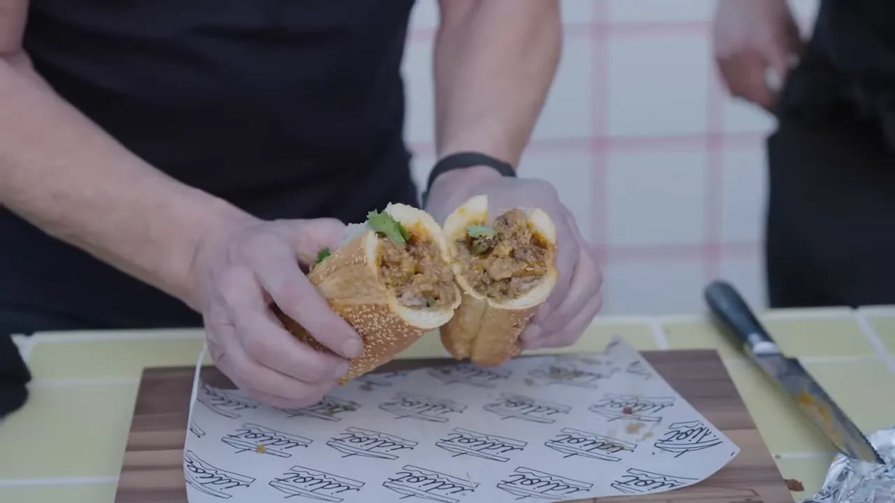 cross-section of a blue cheese hot chicken sandwich showing meat, slaw and bread interior