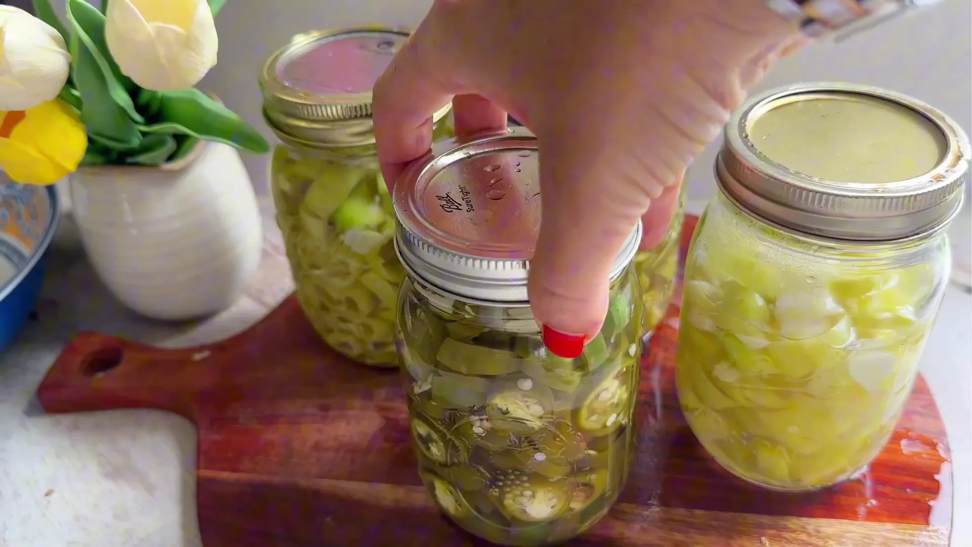 Finished jars of pickled jalapeños and banana peppers ready to refrigerate