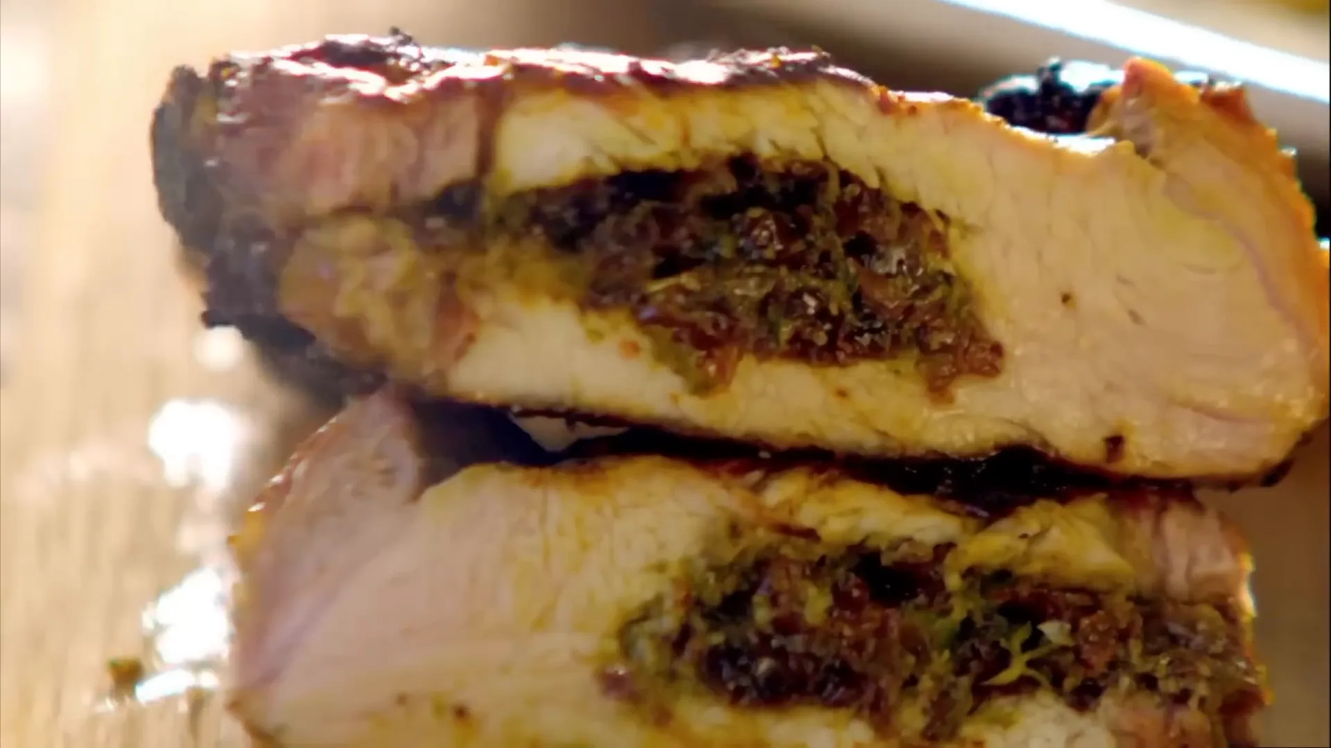 Cut pork chop showing the stuffed centre with raisins and herbs