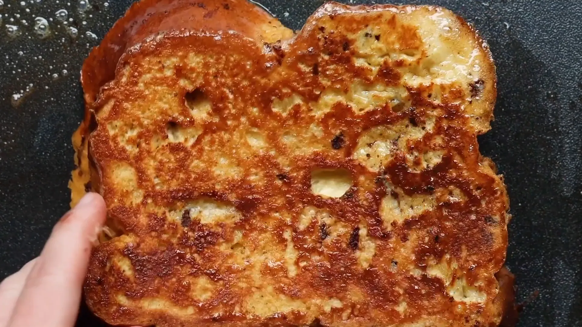 Golden brown French toast cooking on a griddle