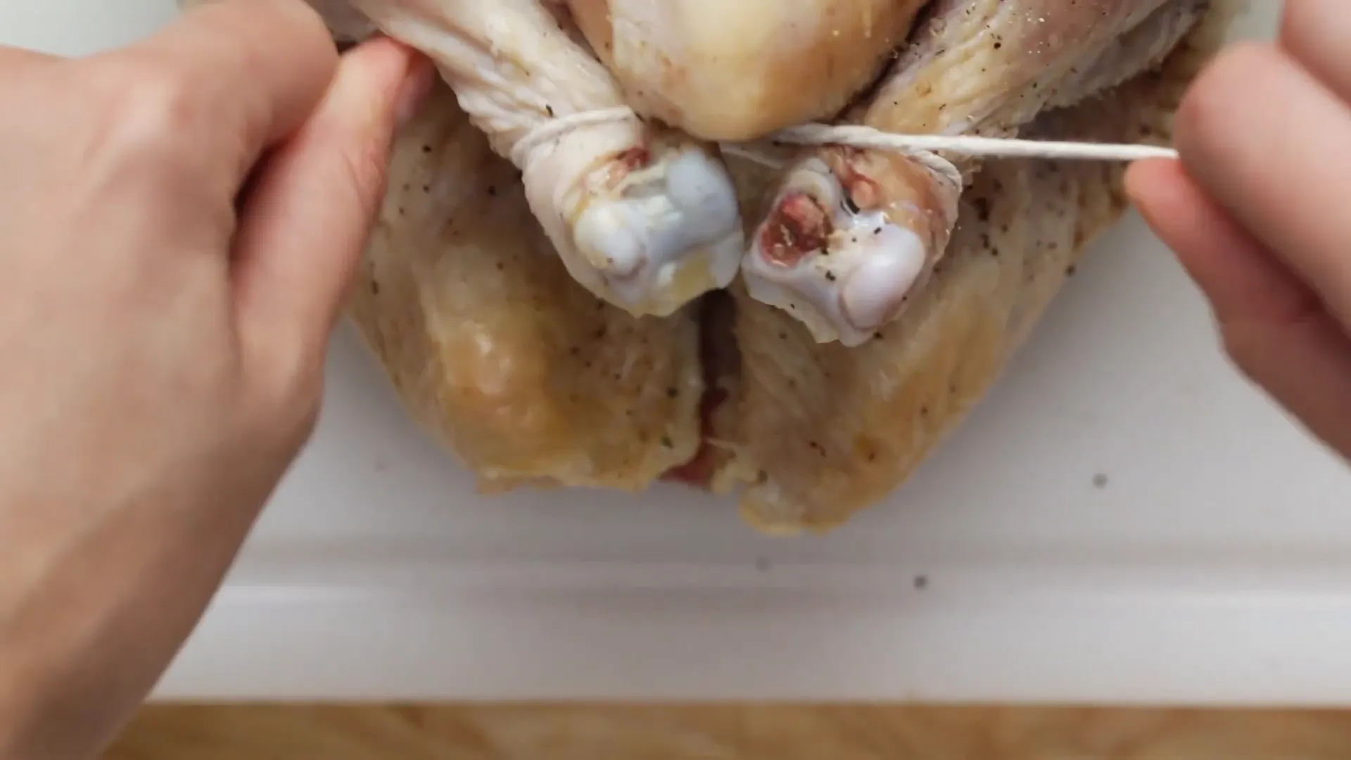 Tying chicken legs with butcher's twine