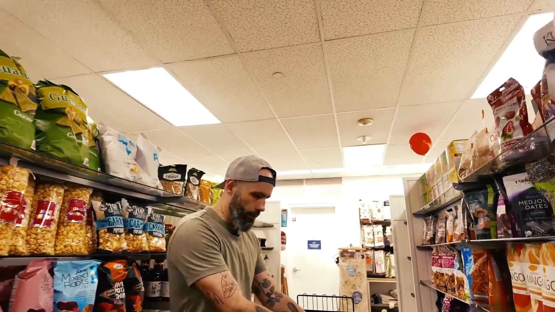 two shoppers pushing carts through Marshalls pantry aisle