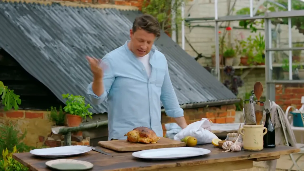 Roast chicken resting on the tray with veg underneath