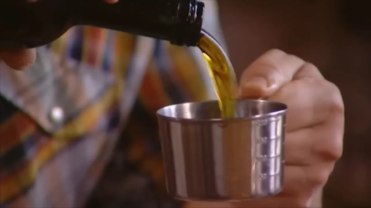 Pouring extra virgin olive oil into the mixing bowl