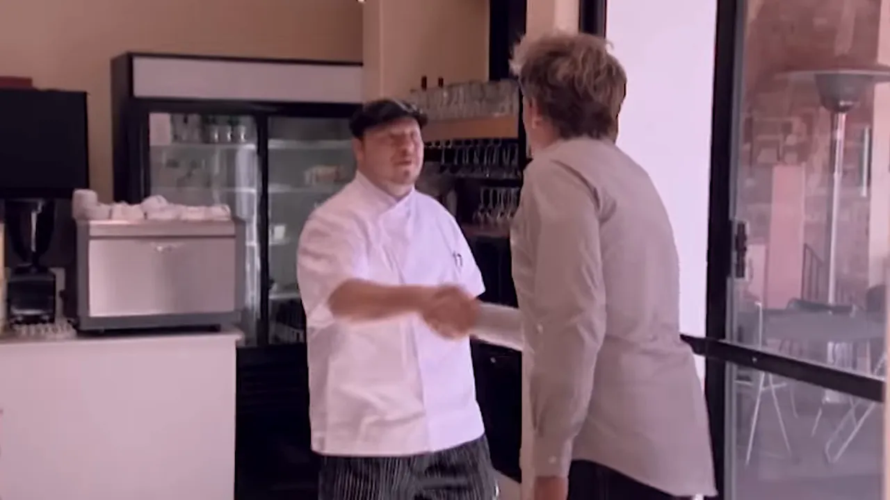 Restaurant host shaking hands with the pizzeria chef near the entrance