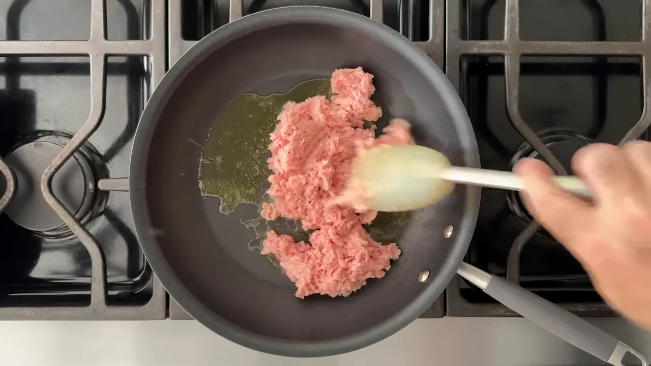 Ground turkey in a skillet beginning to brown
