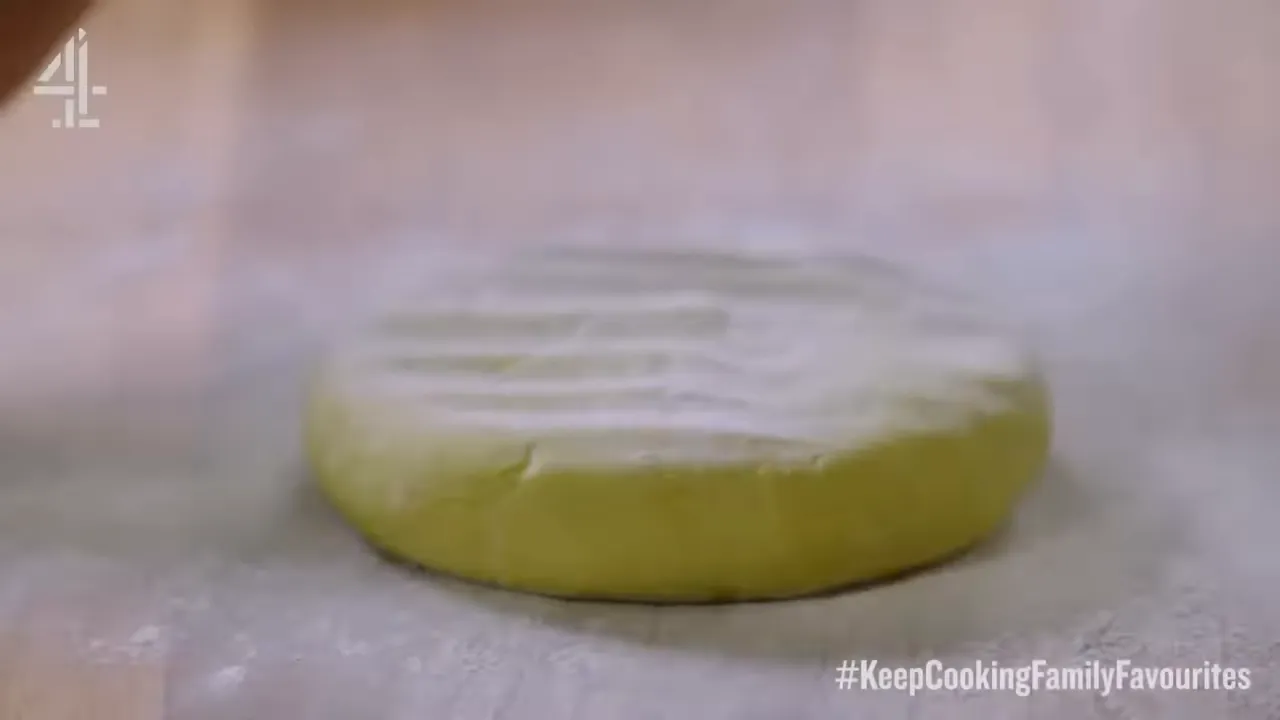 green avocado pastry disc resting on a floured board