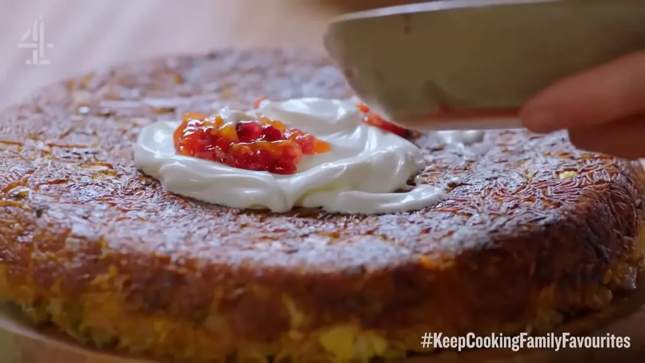 close-up of a crisp rice cake topped with creamy yogurt and a mango-pomegranate dressing