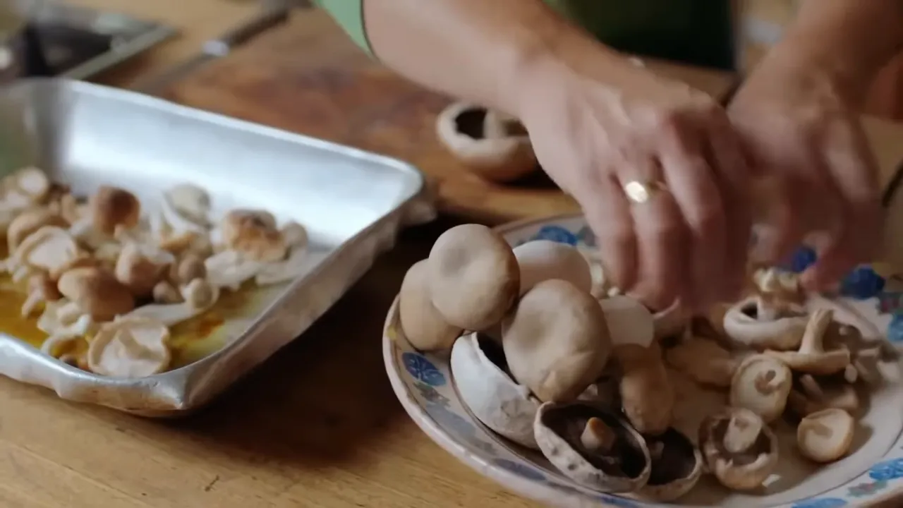 Mixed wild mushrooms sizzling under the chicken in the roasting tray