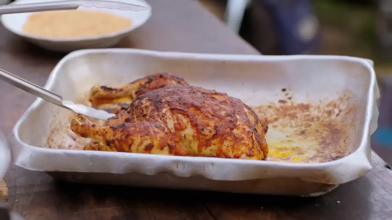 Golden roast chicken being glazed with kimchi-honey sauce