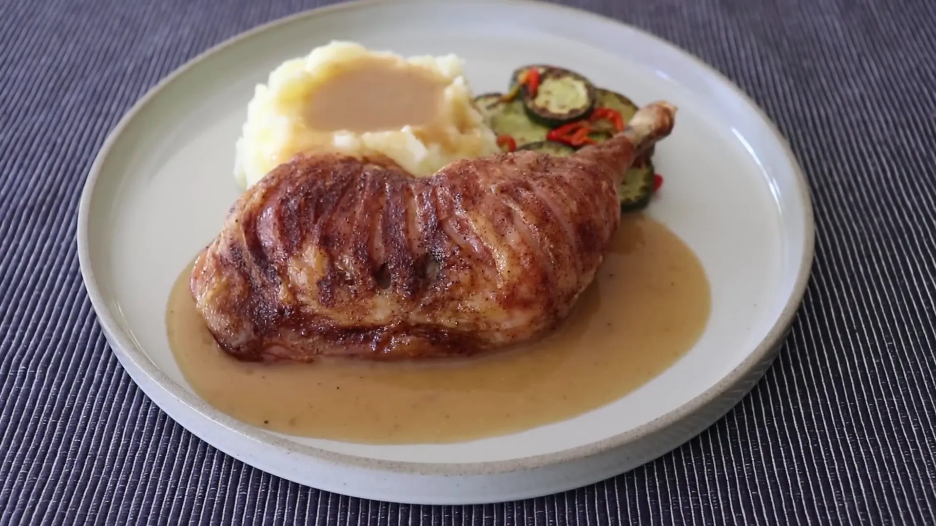 Tiger chicken plated with mashed potatoes and pan gravy