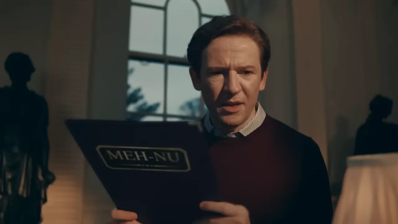 Diner holding a menu labeled 'MEH-NU' in a softly lit restaurant interior